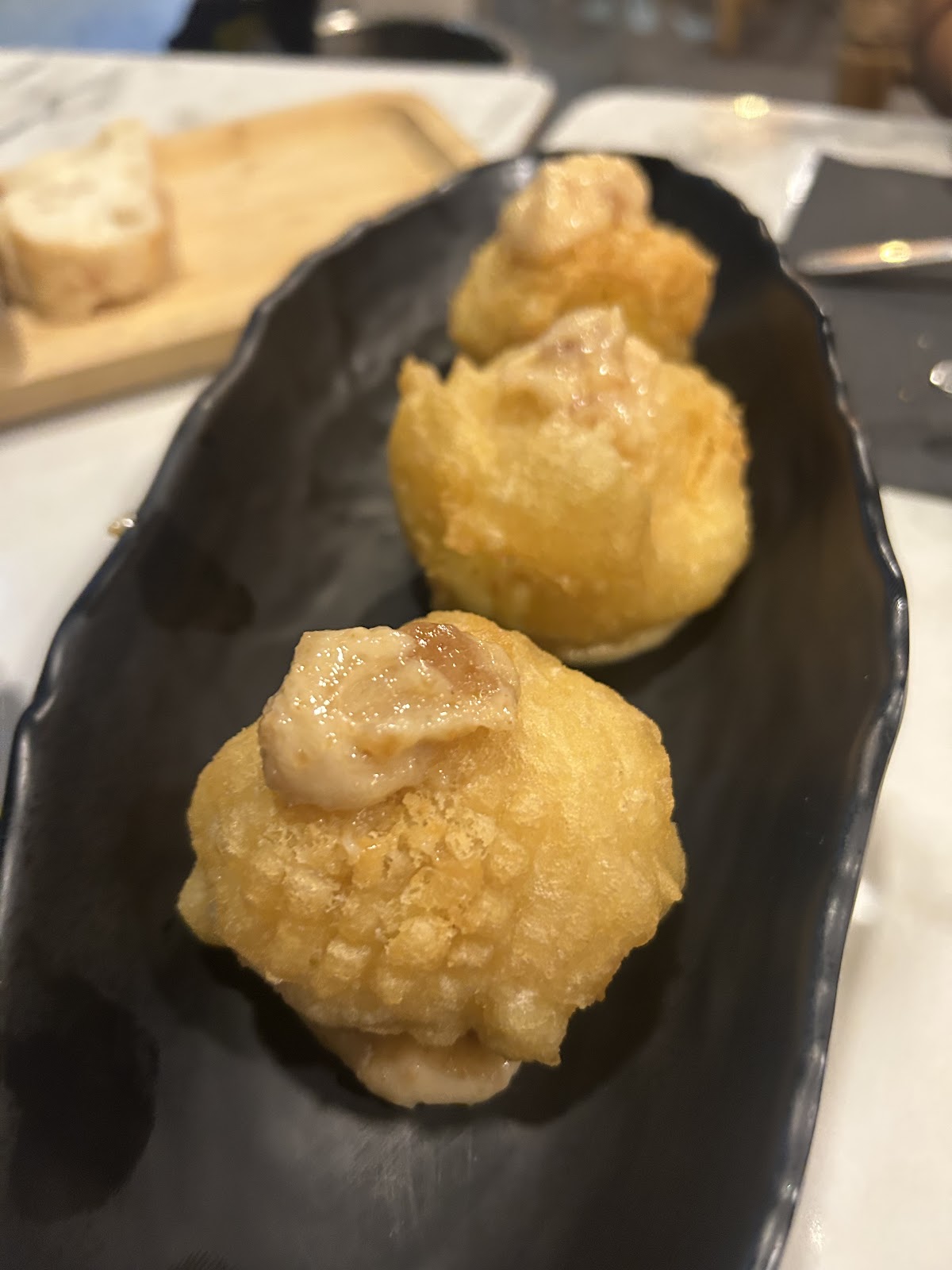Croquetas en plato negro
